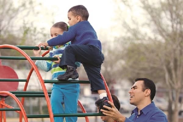 Adult supervising children on playground